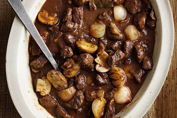 Beef bourguignon stew in an oval dish