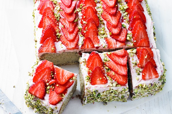 Traybake sponge topped with strawberries and pistachios