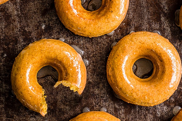 Whole and partially broken ring doughnuts with maple glaze