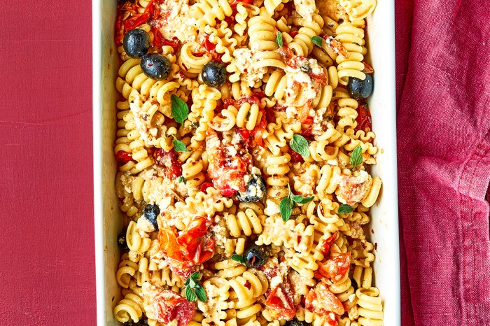 Baked feta pasta with tomatoes and olives, in a baking dish