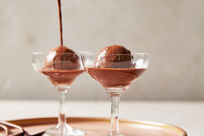 Chocolate ice cream in two glasses with coffee being poured on top