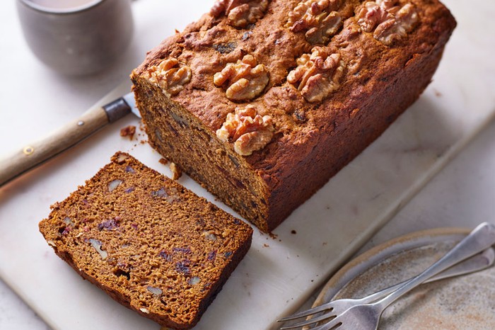 Date and walnut loaf cake with a slice cut
