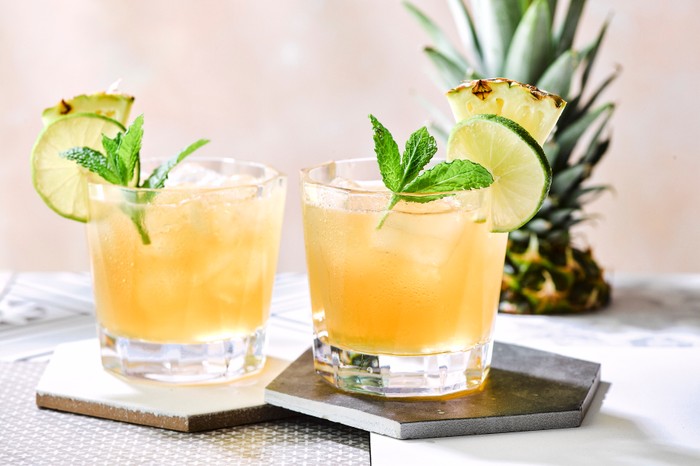 Two mai tai cocktails topped with fresh mint