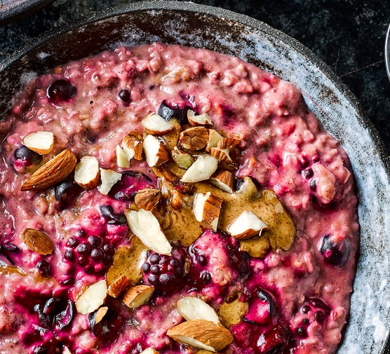 Berry porridge with nut butter in two bowls