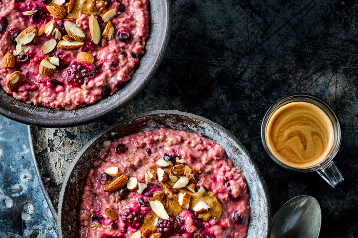 Berry porridge with nut butter in two bowls