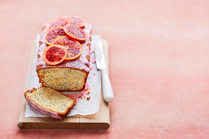 A loaf cake with blood orange slices on top