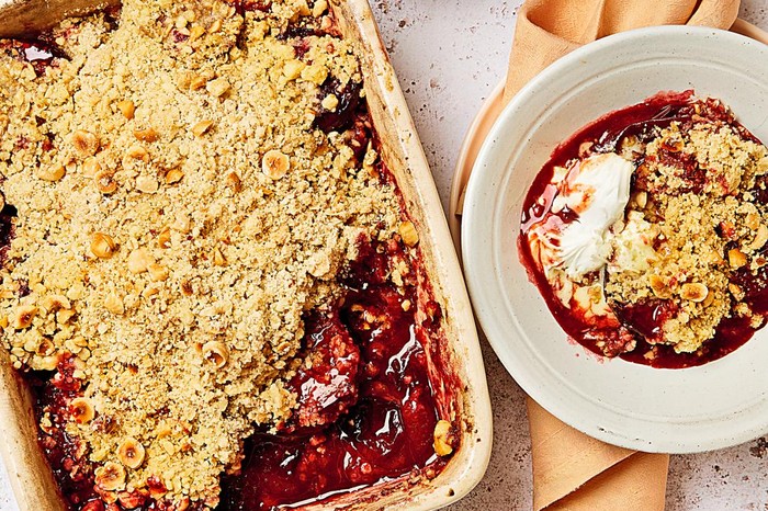 Plum crumble in a serving dish and bowl