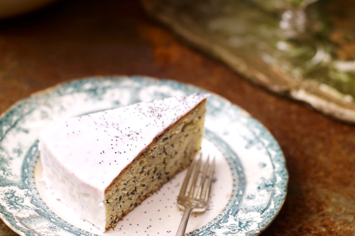 A slice of lemon and poppy seed cake with a dessert fork
