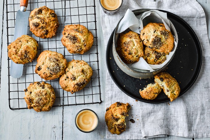 Rock Cakes on a cooling tray with two mugs of coffee