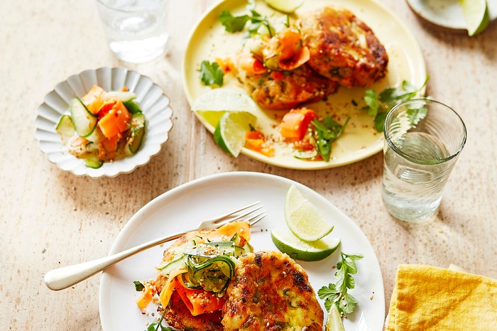 Fish cakes with carrot ribbons and lime wedges