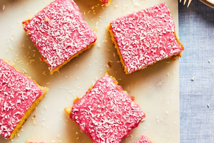 Squares of pink Tottenham cake on a board